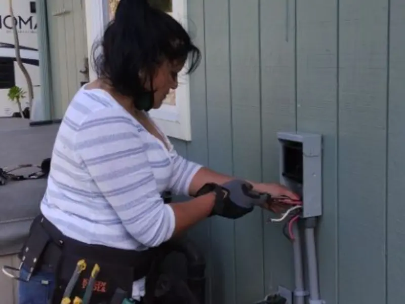 Licensed electrician wiring an exterior subpanel in Hanover Park